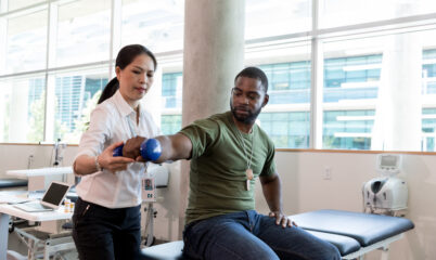 Doctor taking Veteran's blood pressure